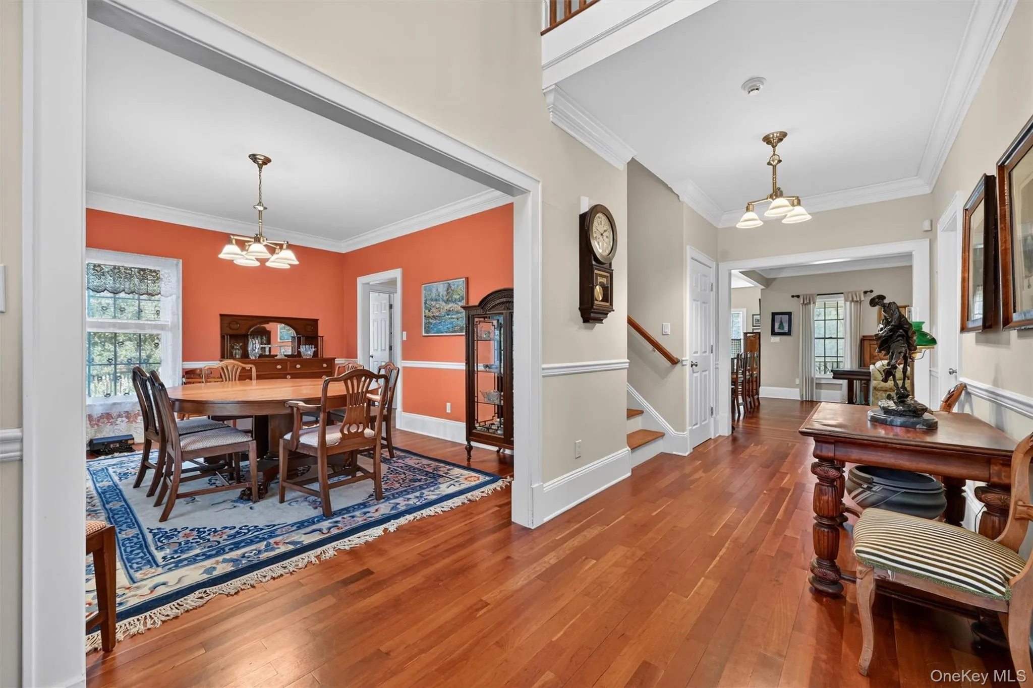 Step in to a bright and welcoming entryway with soaring 9 foot ceilings and rich Brazilian cherry hardwood floors, setting the tone for the craftsmanship and warmth found throughout the home. The Dining Room is to your left, Kitchen and Family Room are straight ahead, and a main floor bedroom (currently used as a Living Room) are to your right. Step in to a bright and welcoming entryway with soaring 9 foot ceilings and rich Brazilian cherry hardwood floors, setting the tone for the craftsmanship and warmth found throughout the home. The Dining Room is to your left, Kitchen and Family Room are straight ahead, and a main floor bedroom (currently used as a Living Room) are to your right.