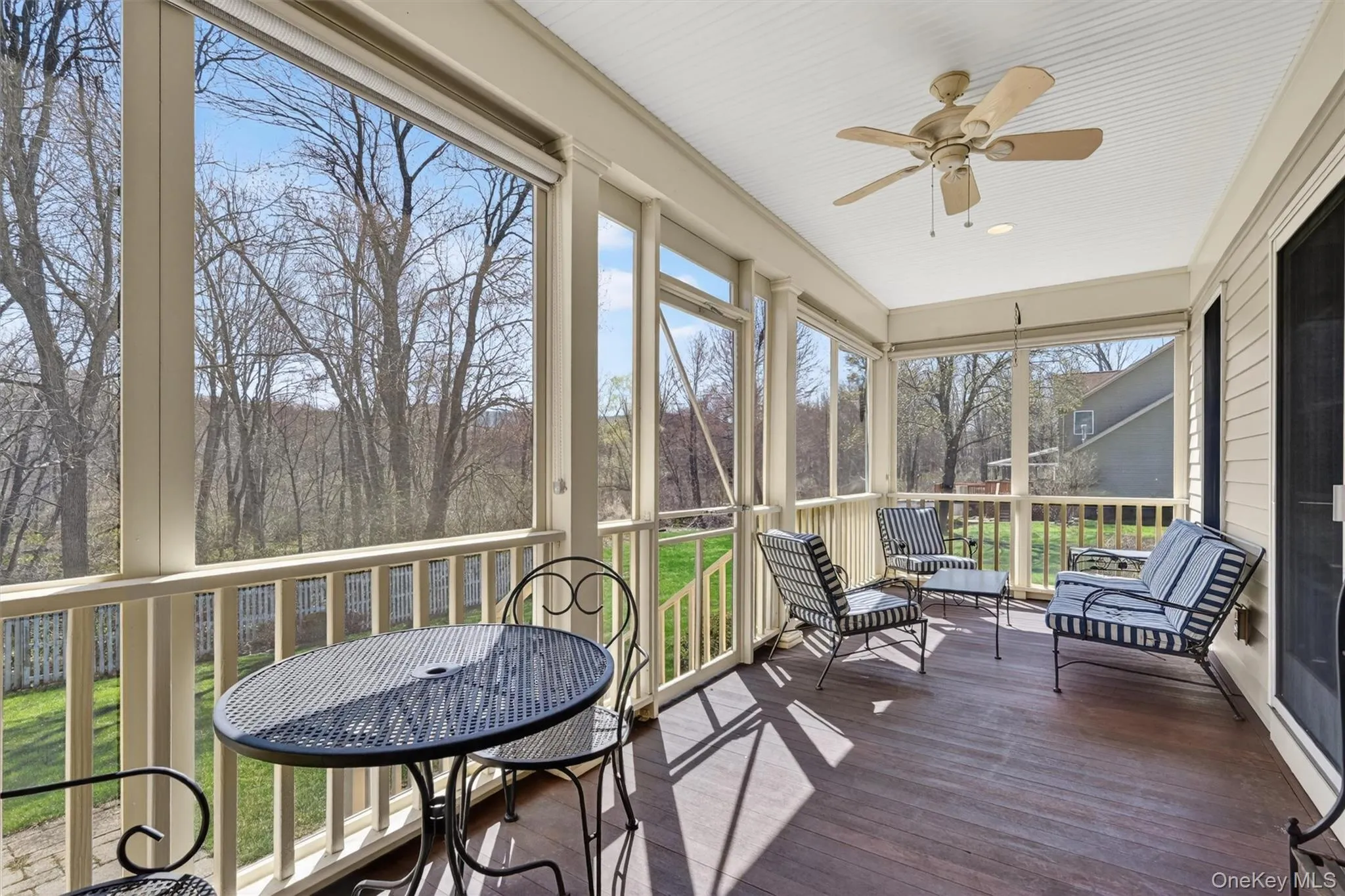 The screened porch in the back of the home is accessible from both the kitchen and family room. It is the perfect place to relax, dine, or unwind while enjoying peaceful outdoor views. The porch features custom removable screen panels, allowing you to enjoy it as a screened retreat or open-air space depending on the season and your preference. The screened porch in the back of the home is accessible from both the kitchen and family room. It is the perfect place to relax, dine, or unwind while enjoying peaceful outdoor views. The porch features custom removable screen panels, allowing you to enjoy it as a screened retreat or open-air space depending on the season and your preference.