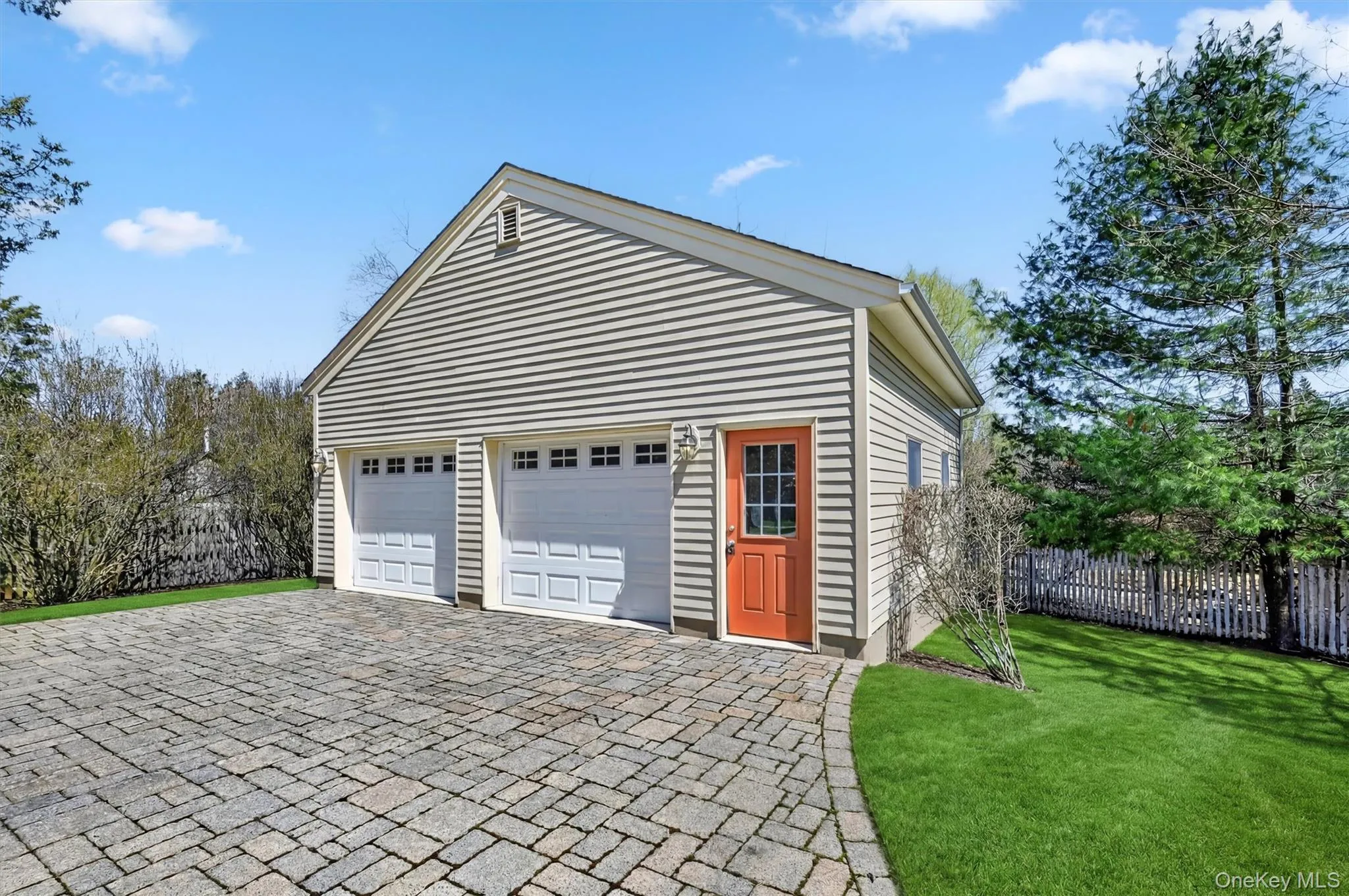 A closer look at the detached two-car garage, complete with upper-level storage, ideal for hobbies, seasonal items, or extra space. A closer look at the detached two-car garage, complete with upper-level storage, ideal for hobbies, seasonal items, or extra space.