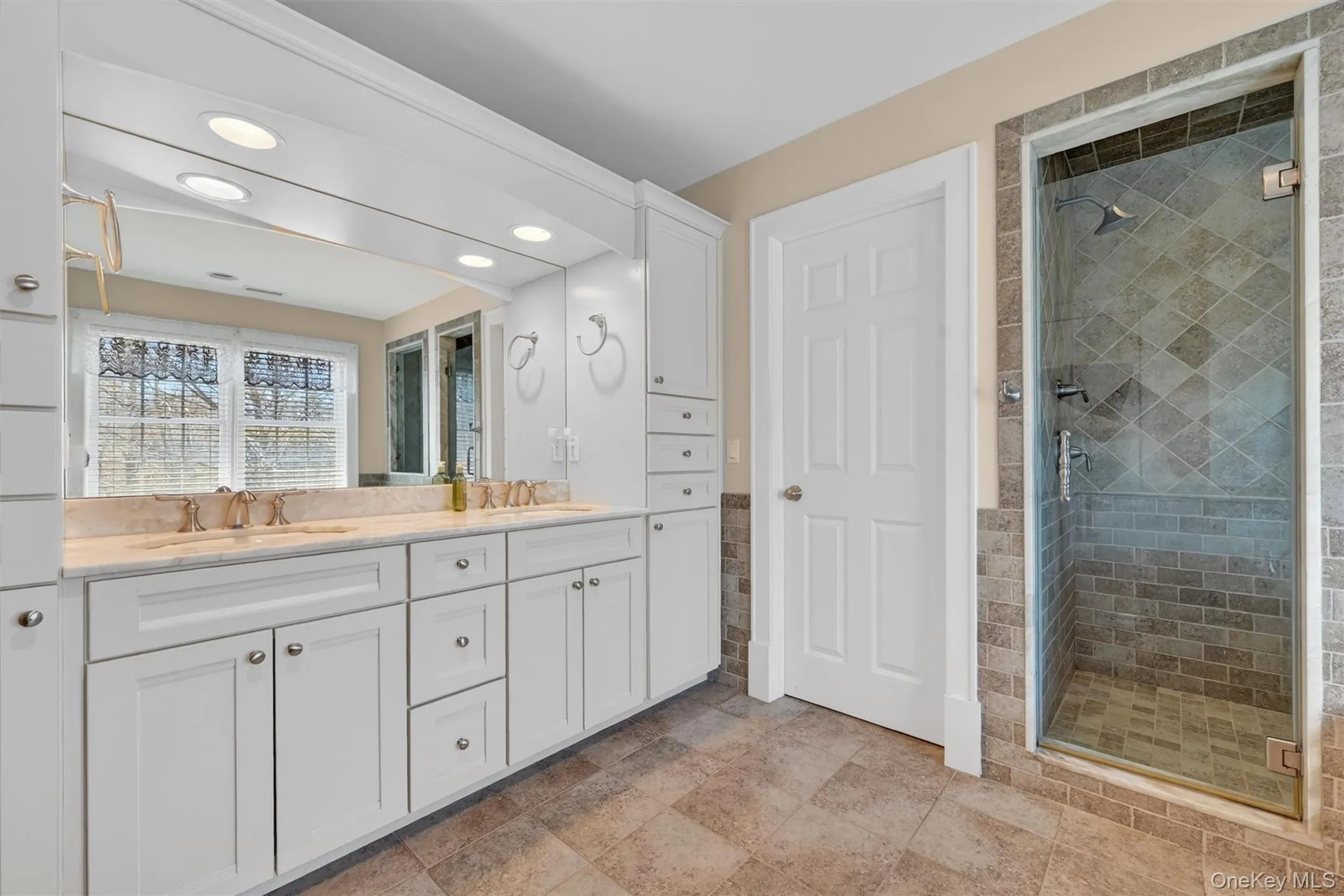 The primary ensuite features a double vanity with generous storage and a beautifully tiled walk-in shower for a clean, modern feel. The primary ensuite features a double vanity with generous storage and a beautifully tiled walk-in shower for a clean, modern feel.
