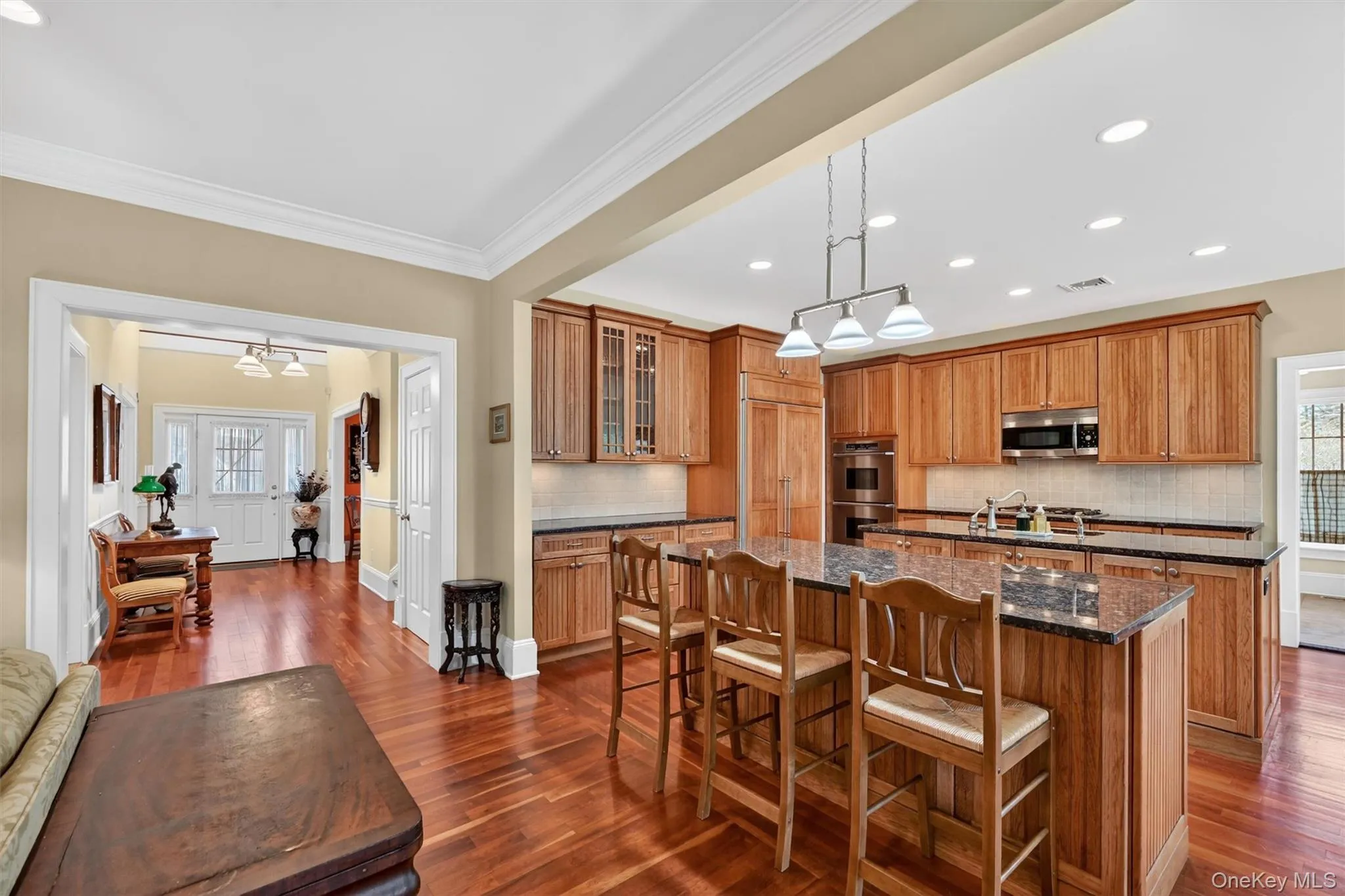 Two expansive islands anchor the kitchen, offering ample prep space, casual seating, and the ideal setup for hosting and gathering. Two expansive islands anchor the kitchen, offering ample prep space, casual seating, and the ideal setup for hosting and gathering.