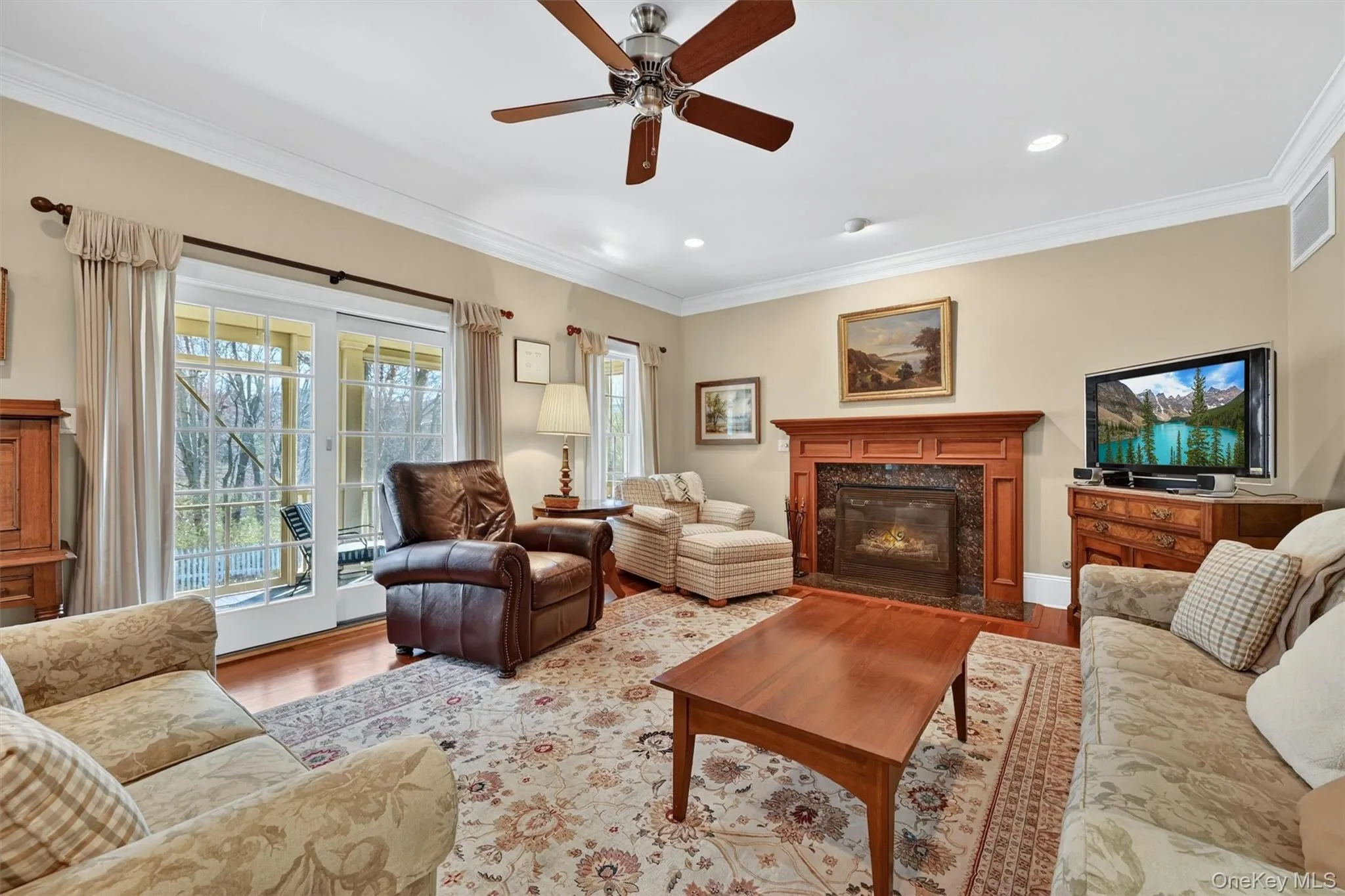 The family room offers a comfortable and inviting space to gather, centered around a gas fireplace and filled with natural light from sliding doors leading to the porch. The family room offers a comfortable and inviting space to gather, centered around a gas fireplace and filled with natural light from sliding doors leading to the porch.