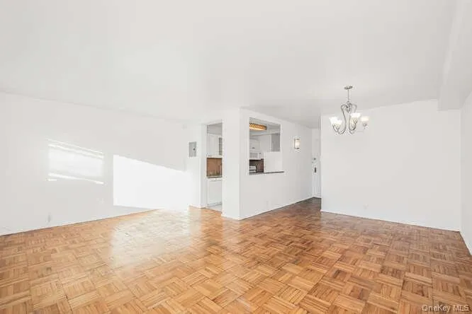 Living room and dining area with a chandelier Living room and dining area with a chandelier