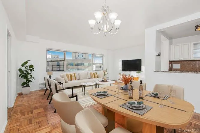 Virtually staged Living area featuring a chandelier Virtually staged Living area featuring a chandelier