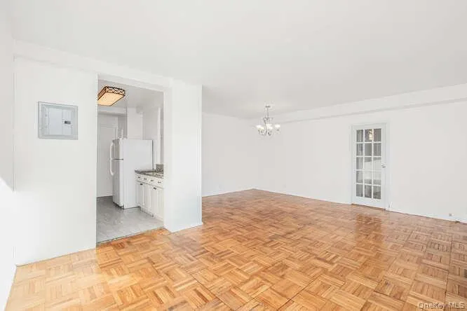 Living room and dining area with a chandelier Living room and dining area with a chandelier