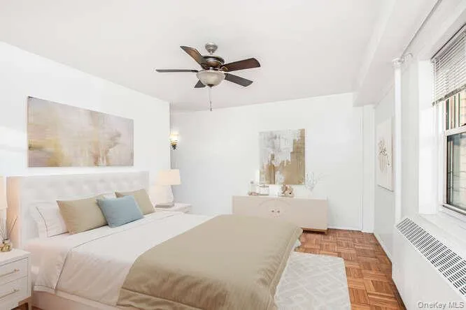 Virtually staged Primary Bedroom with radiator and a ceiling fan Virtually staged Primary Bedroom with radiator and a ceiling fan