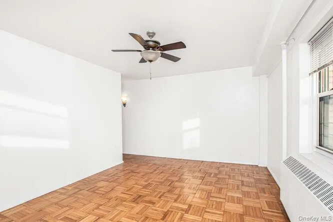 Primary Bedroom with radiator and ceiling fan Primary Bedroom with radiator and ceiling fan