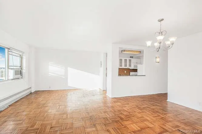 Unfurnished living room featuring a chandelier Unfurnished living room featuring a chandelier