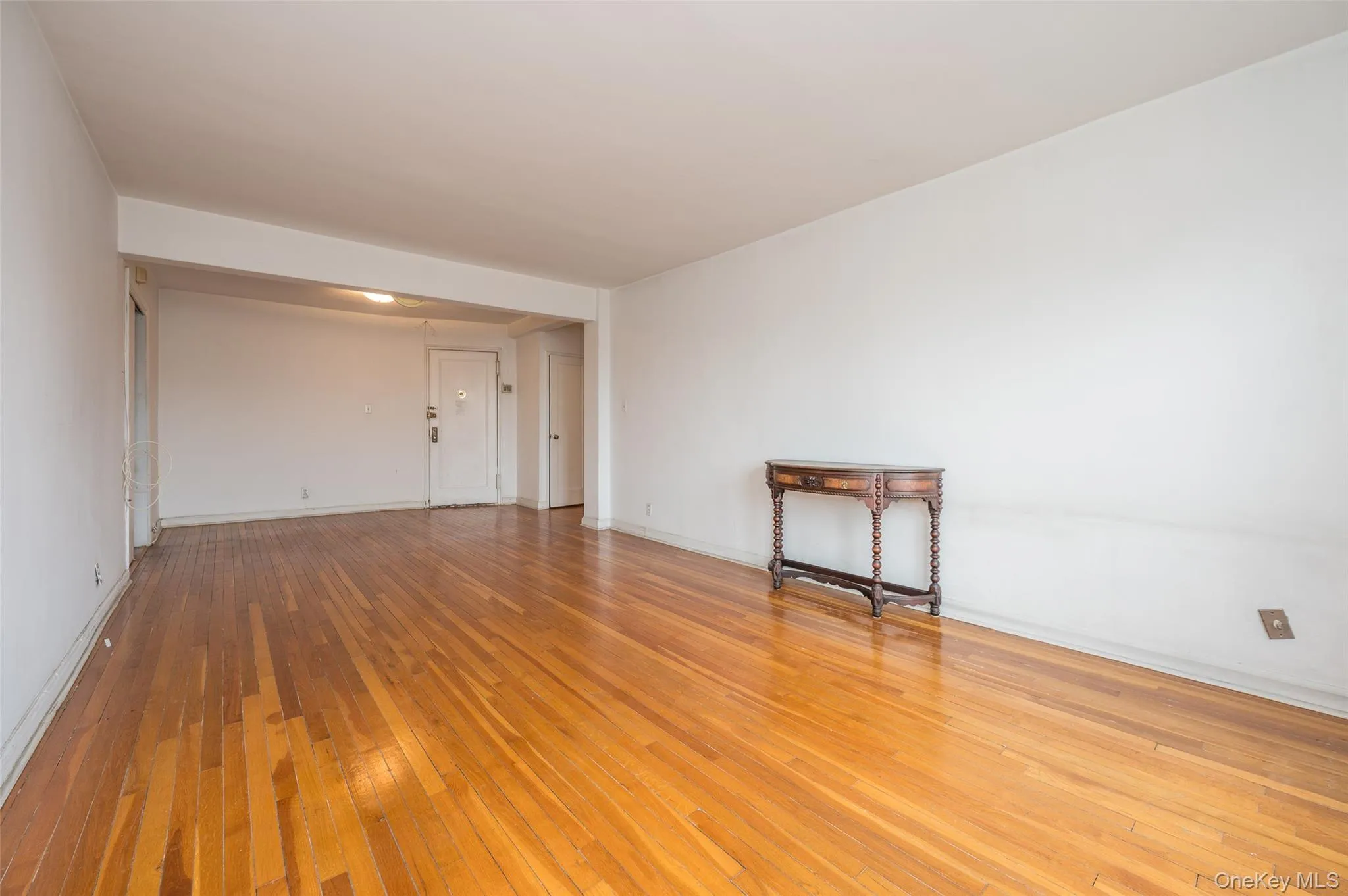 Empty room with light wood-style flooring and baseboards Empty room with light wood-style flooring and baseboards