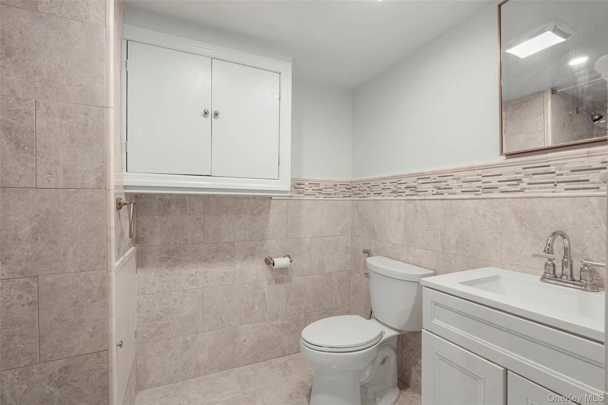 Lower level powder room. Lower level powder room.