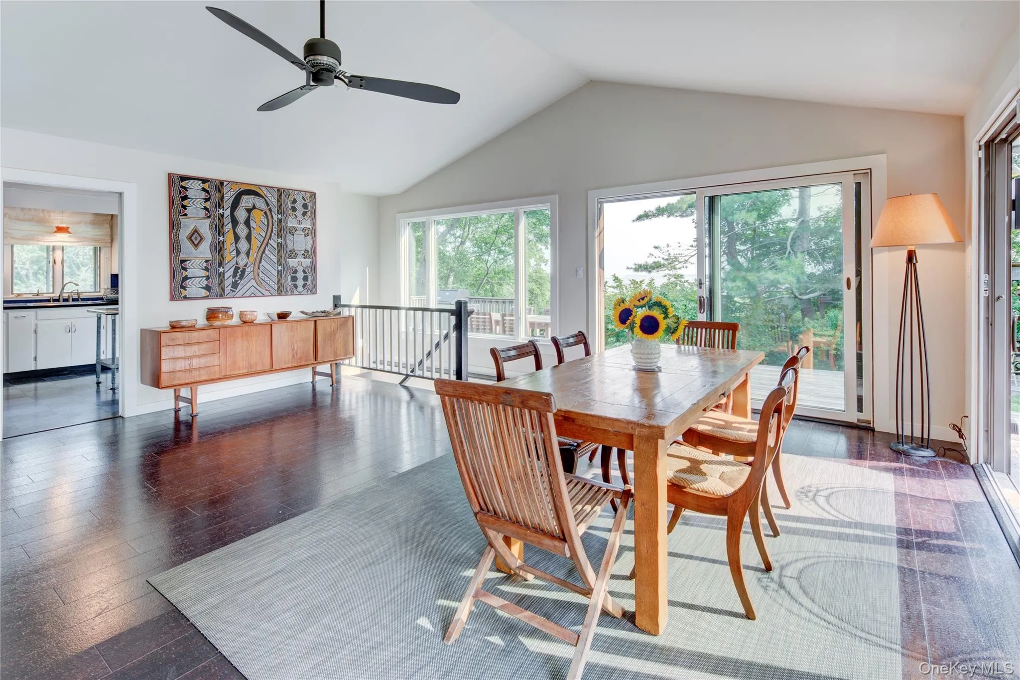Dining space featuring vaulted ceiling, dark hardwood floor Dining space featuring vaulted ceiling, dark hardwood floor