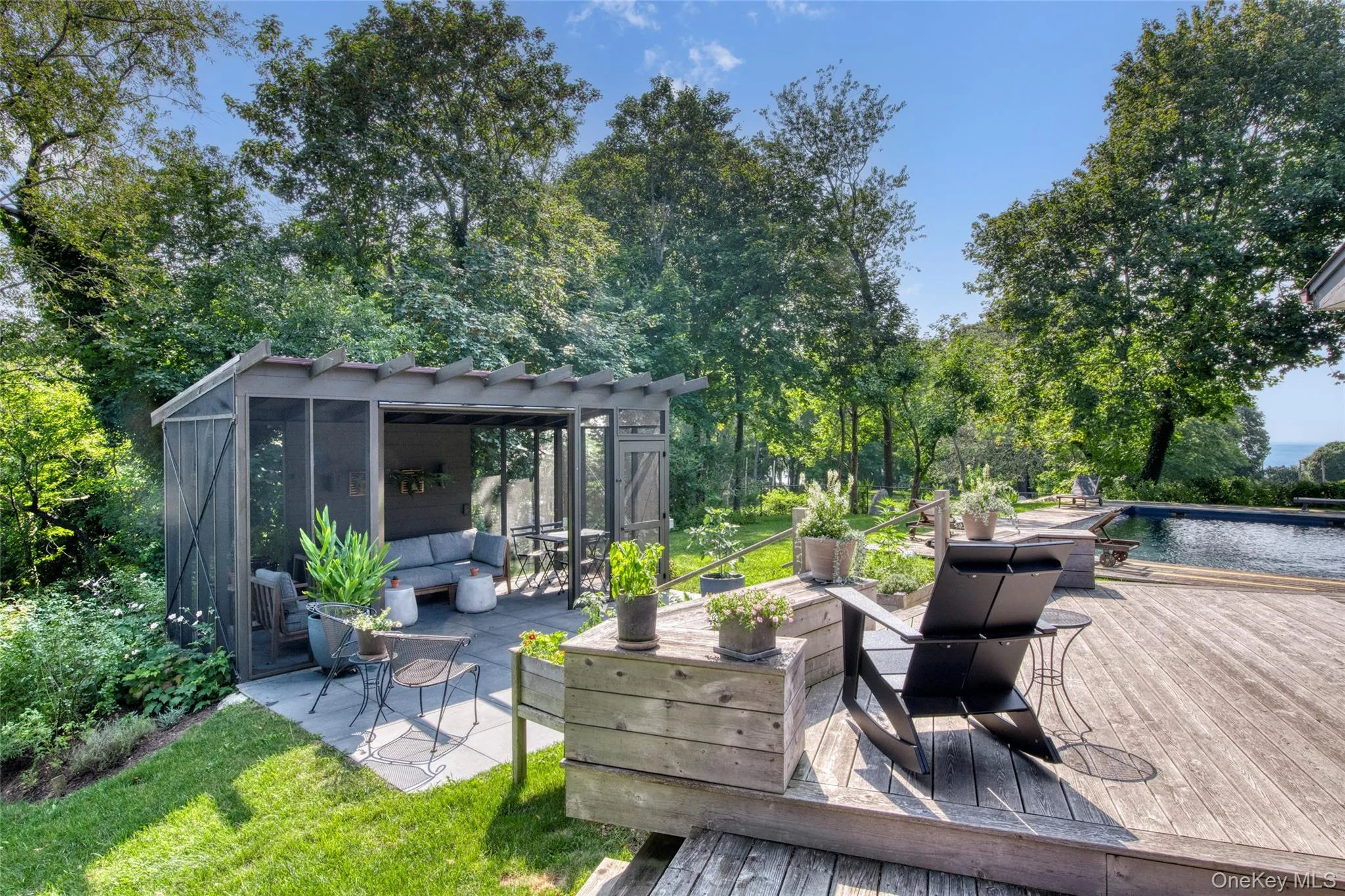 Wooden deck featuring an outdoor living space and an outdoor structure Wooden deck featuring an outdoor living space and an outdoor structure