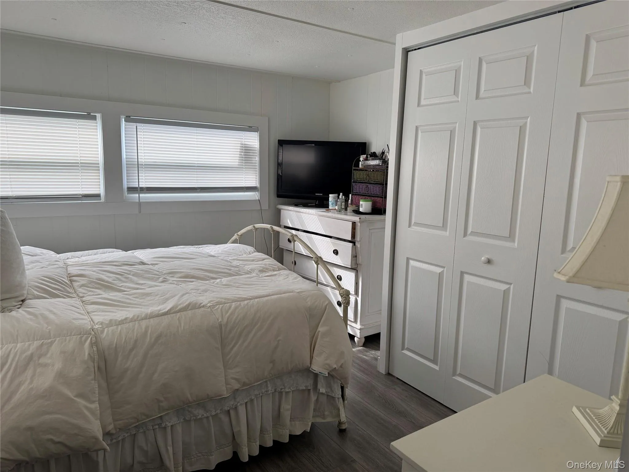 Bedroom featuring vinyl type flooring and a closet Bedroom featuring vinyl type flooring and a closet