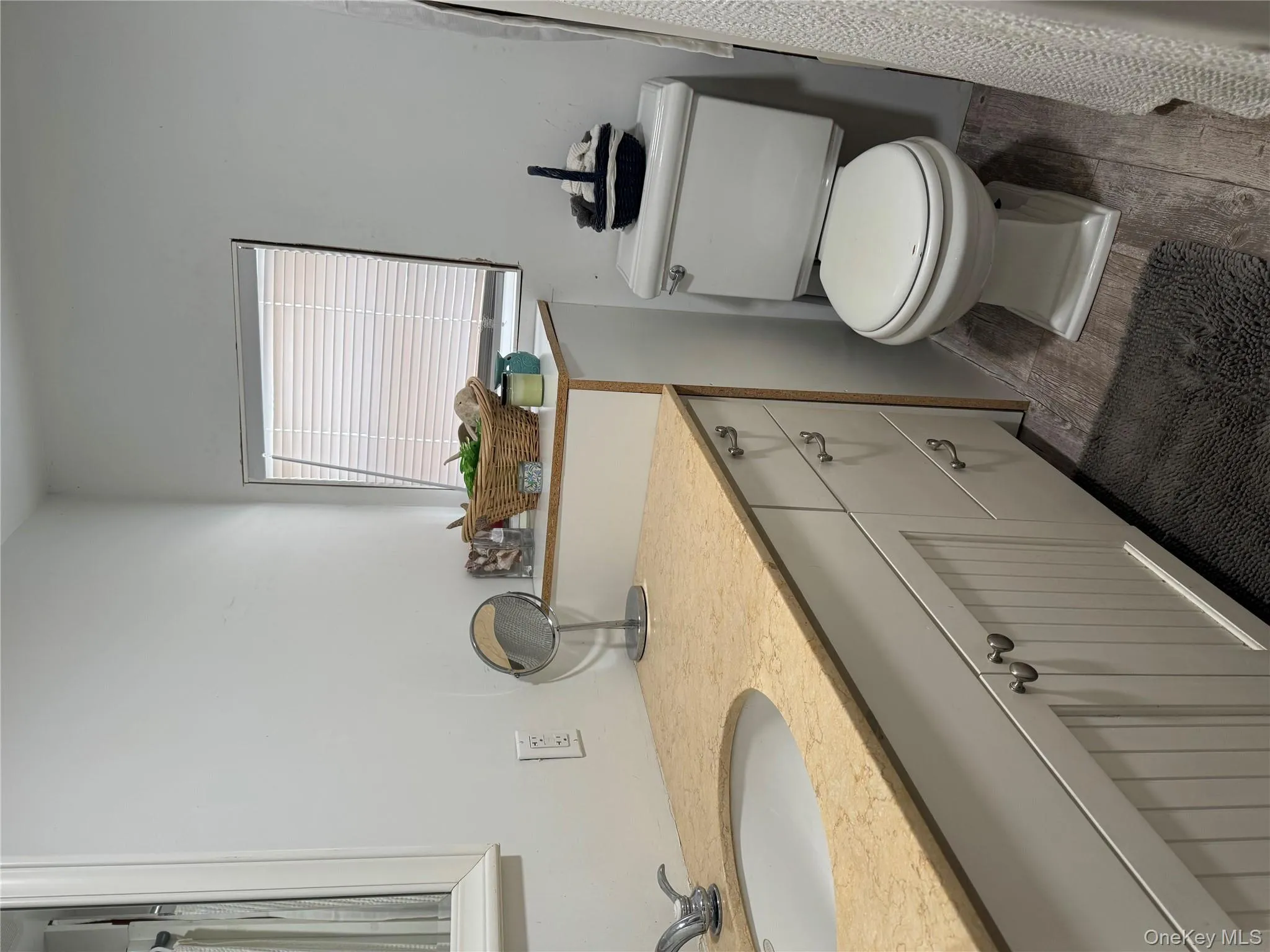 Bathroom featuring vanity, hardwood / wood-style flooring, and toilet Bathroom featuring vanity, hardwood / wood-style flooring, and toilet