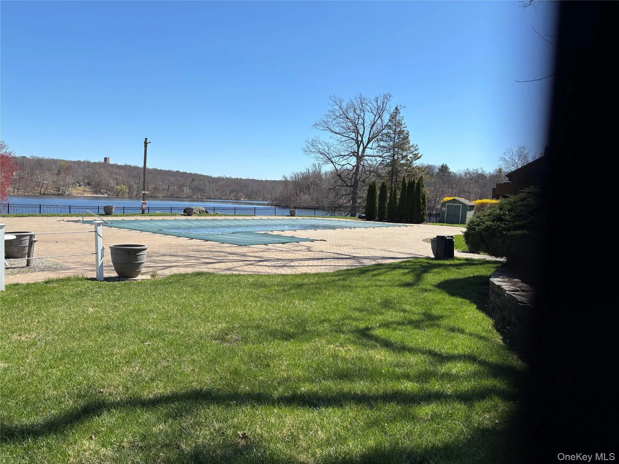Community pool, view of lake in the background. Community pool, view of lake in the background.