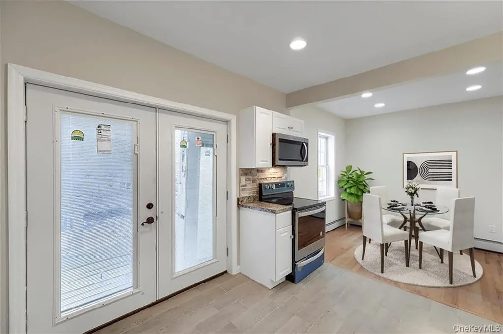 Virtually Staged, Functional kitchen layout featuring direct access to the exterior, ideal for everyday convenience. Virtually Staged, Functional kitchen layout featuring direct access to the exterior, ideal for everyday convenience.