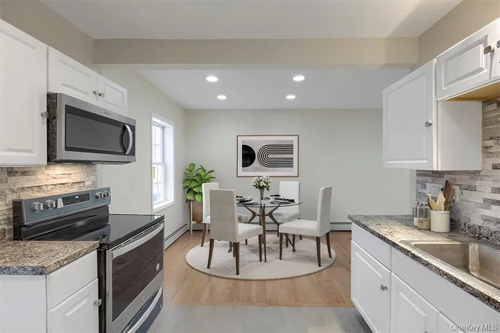 Virtually Staged, Stylish kitchen featuring stainless steel appliances, tile backsplash, and ample counter space. Virtually Staged, Stylish kitchen featuring stainless steel appliances, tile backsplash, and ample counter space.