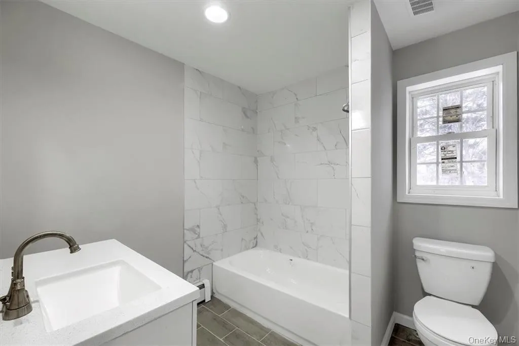 Beautifully updated bathroom featuring a tiled tub/shower, modern vanity, and clean finishes throughout. Beautifully updated bathroom featuring a tiled tub/shower, modern vanity, and clean finishes throughout.