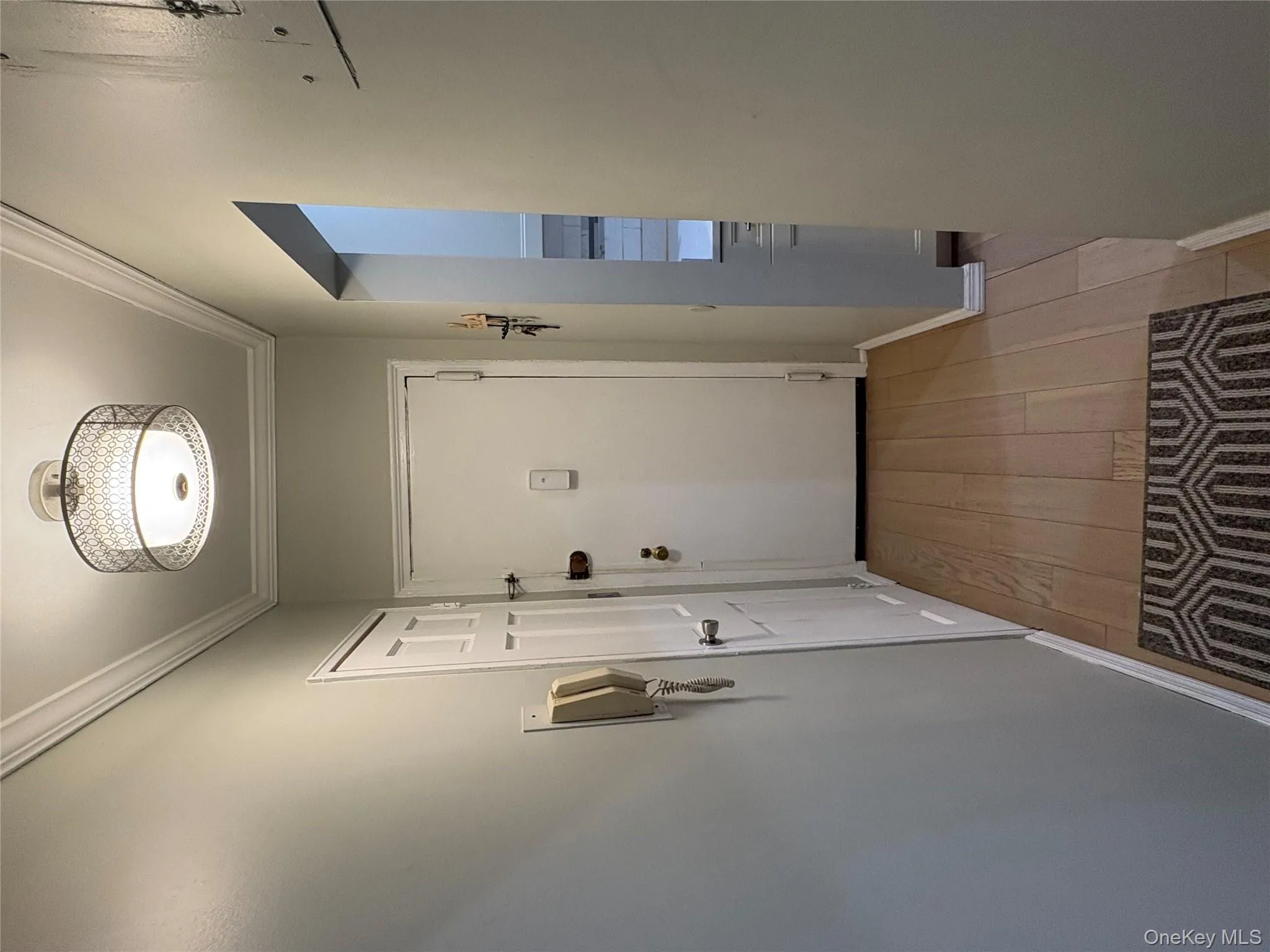 Doorway to outside featuring ornamental molding and wood finished floors Doorway to outside featuring ornamental molding and wood finished floors