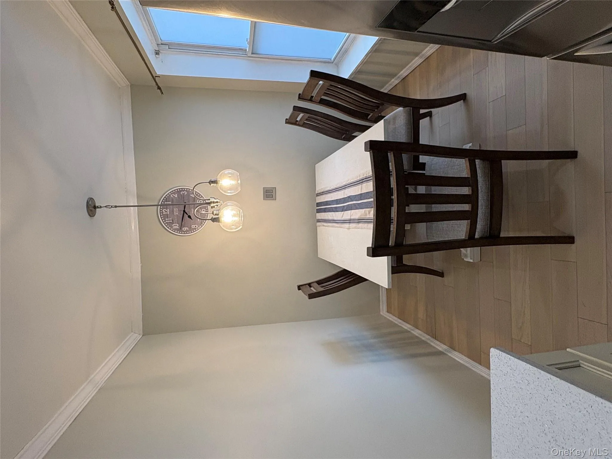 Dining area featuring dark wood-type flooring, ornamental molding, and hanging lights Dining area featuring dark wood-type flooring, ornamental molding, and hanging lights