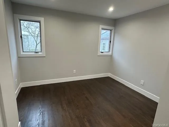 Bedroom featuring dark wood-type flooring and recessed lighting Bedroom featuring dark wood-type flooring and recessed lighting