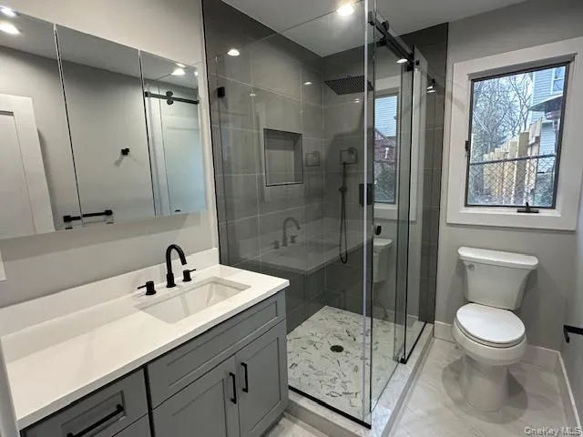 Full bath featuring vanity and a shower stall Full bath featuring vanity and a shower stall