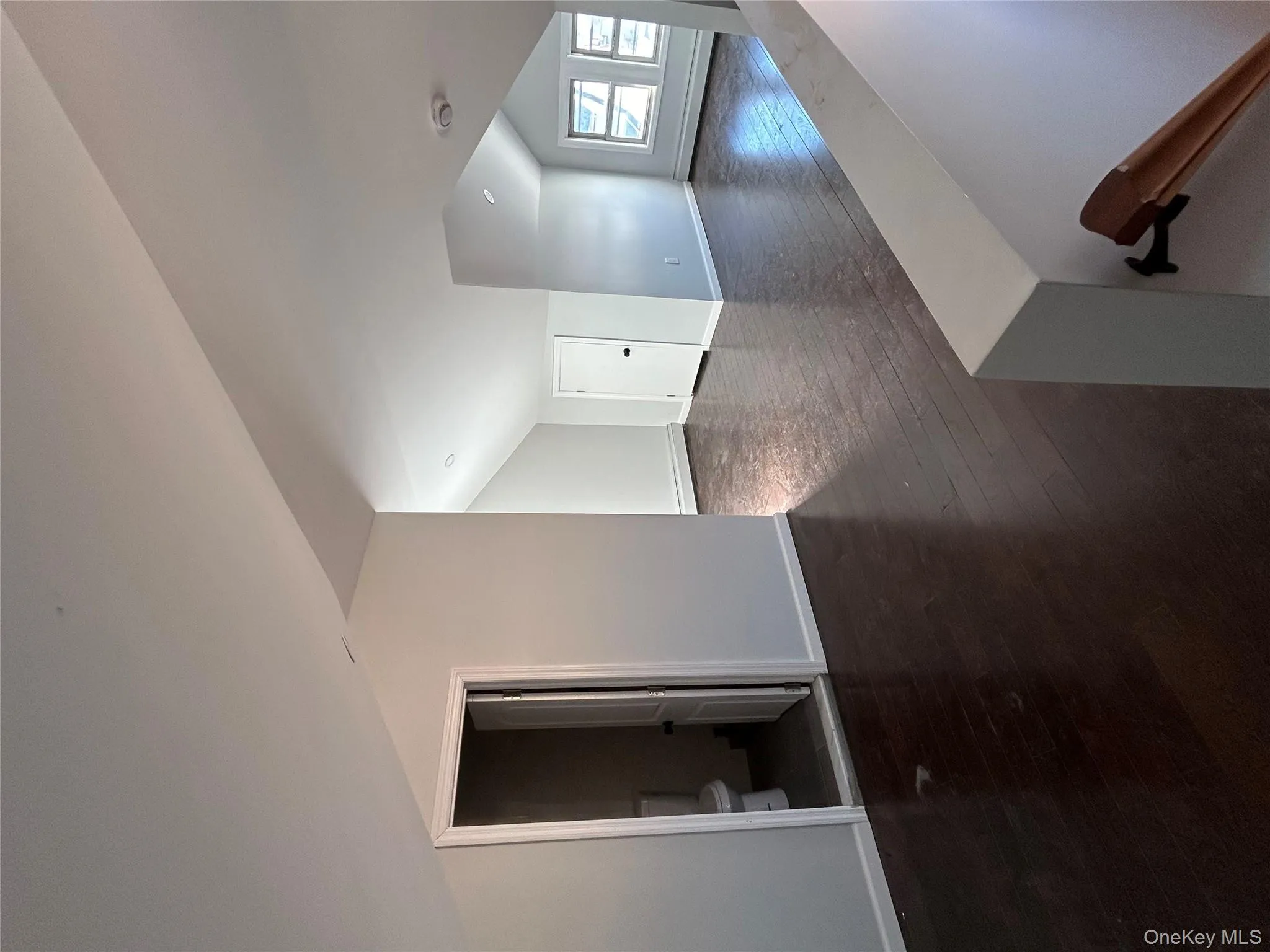 Additional living space featuring dark wood-type flooring, vaulted ceiling, and a baseboard heating unit Additional living space featuring dark wood-type flooring, vaulted ceiling, and a baseboard heating unit