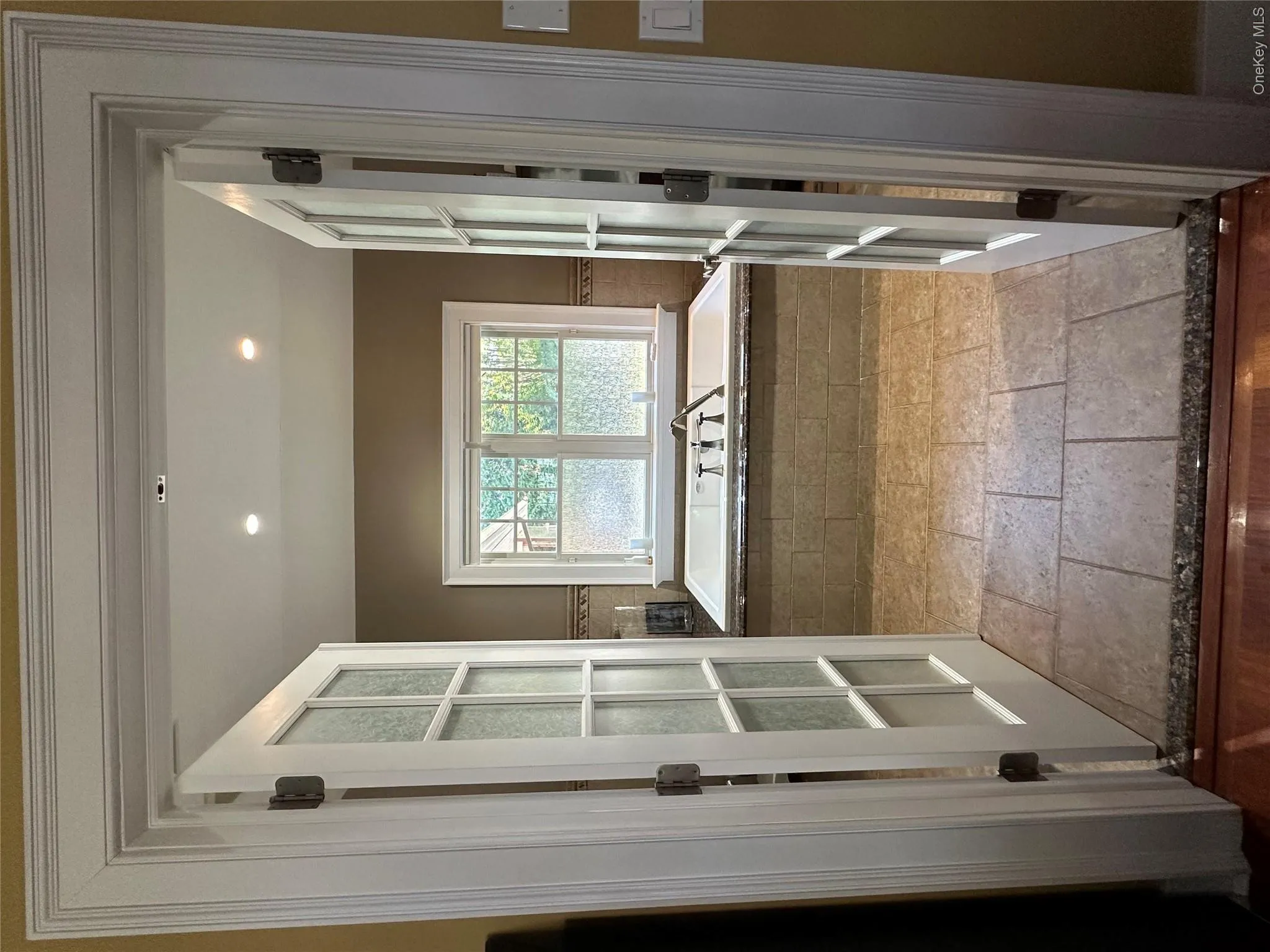 Full bathroom with a bath, french doors, stone tile floors, and recessed lighting Full bathroom with a bath, french doors, stone tile floors, and recessed lighting