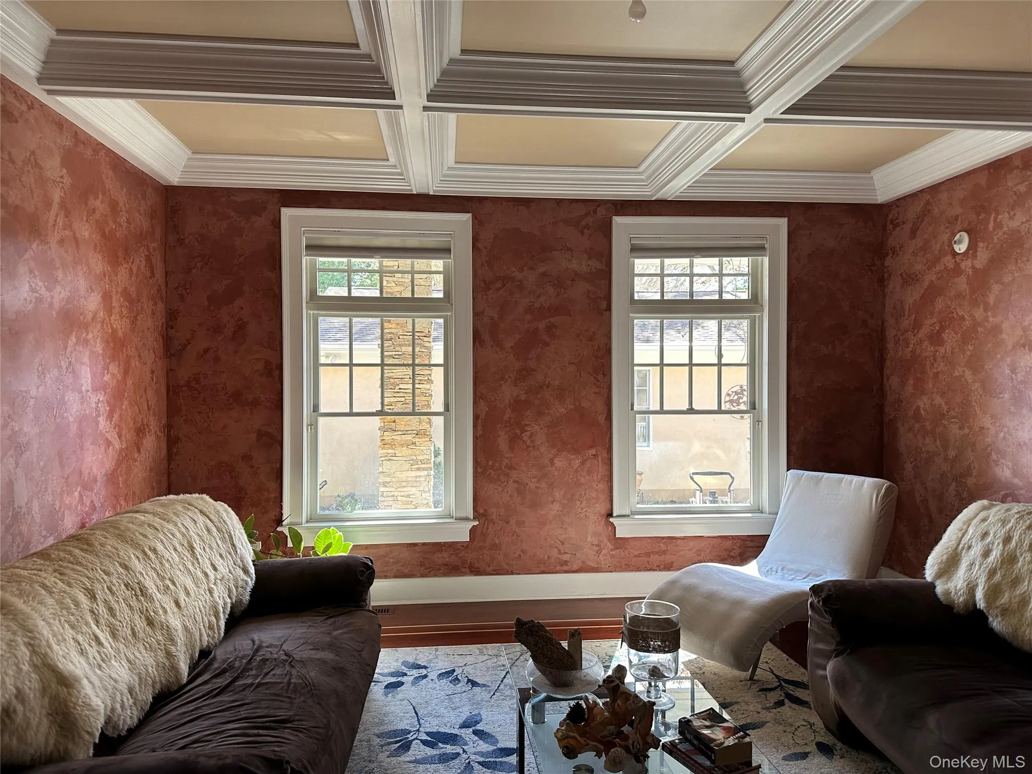 Currently used as a sitting room with healthy amount of natural light, beam ceiling, coffered ceiling, wood finished floors, and crown molding Currently used as a sitting room with healthy amount of natural light, beam ceiling, coffered ceiling, wood finished floors, and crown molding