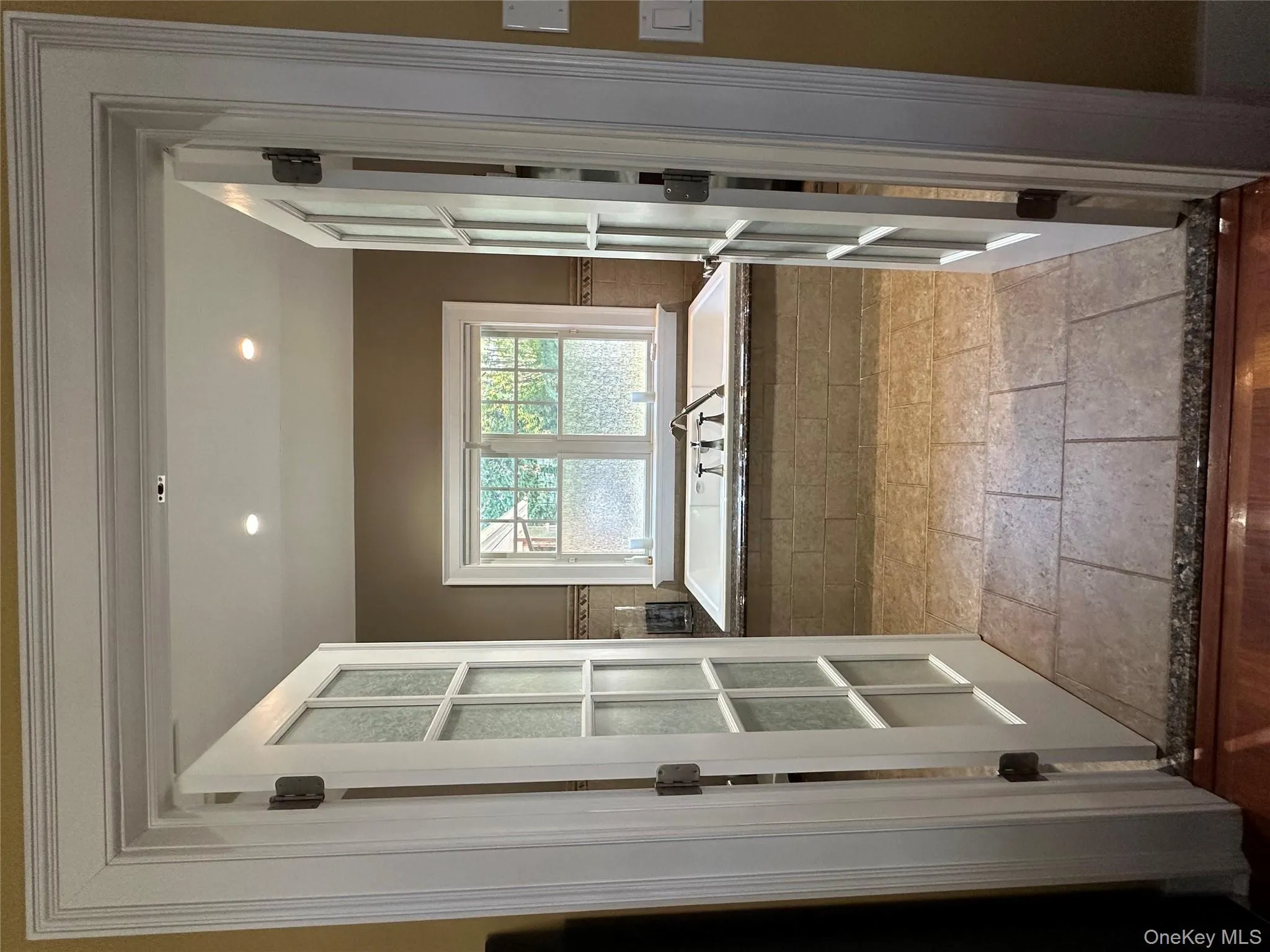 Full bathroom with a bath, french doors, stone tile floors, and recessed lighting Full bathroom with a bath, french doors, stone tile floors, and recessed lighting