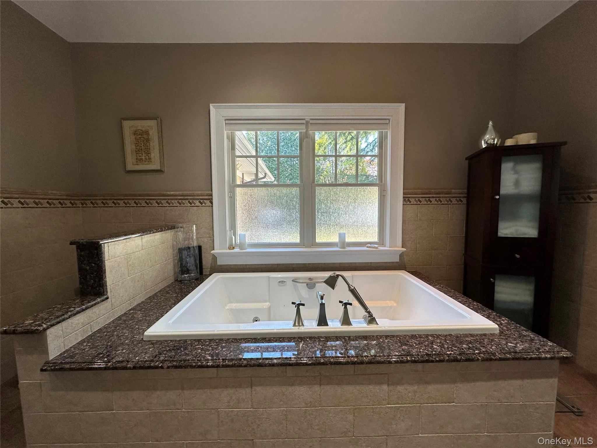 Full bathroom featuring a jetted tub Full bathroom featuring a jetted tub