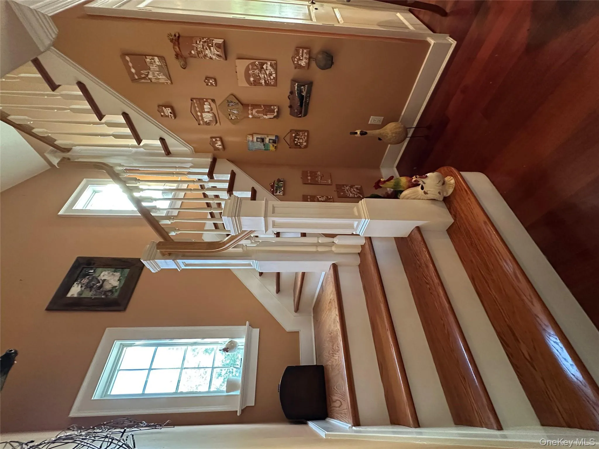 Staircase with healthy amount of natural light and wood finished floors leading to the unfinished 2nd floor Staircase with healthy amount of natural light and wood finished floors leading to the unfinished 2nd floor