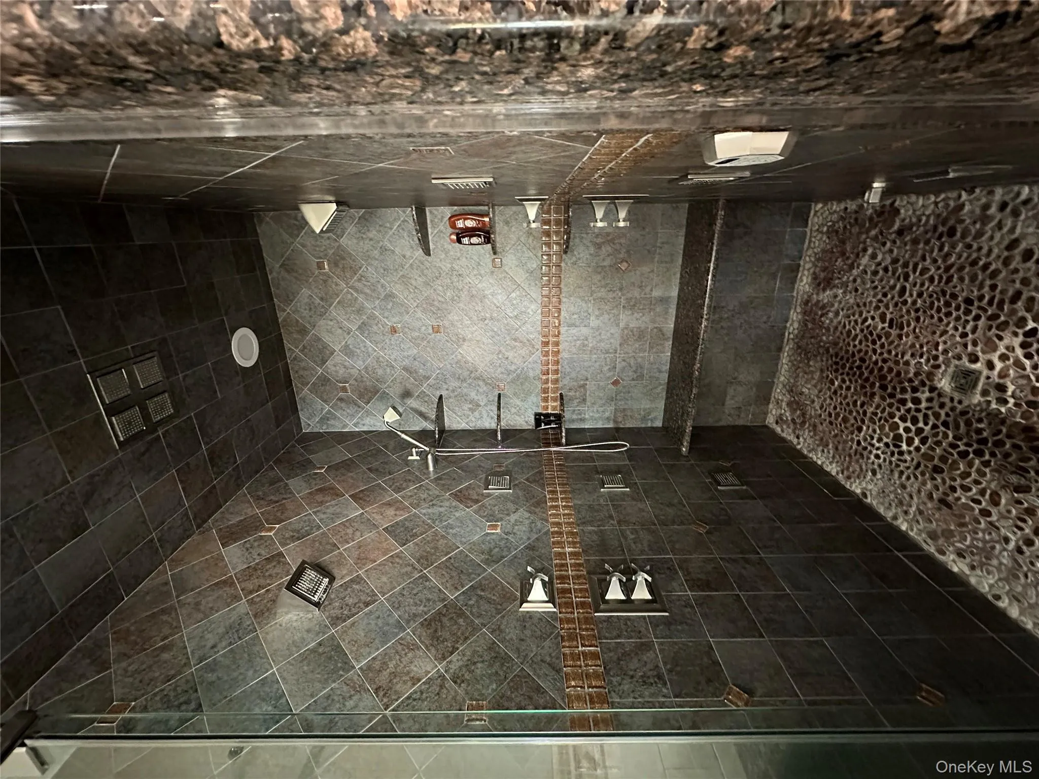 Bathroom with fully enclosed steam shower, Italian tile shower and Spanish glass inlay, natural stone base with more jets than you can count Bathroom with fully enclosed steam shower, Italian tile shower and Spanish glass inlay, natural stone base with more jets than you can count