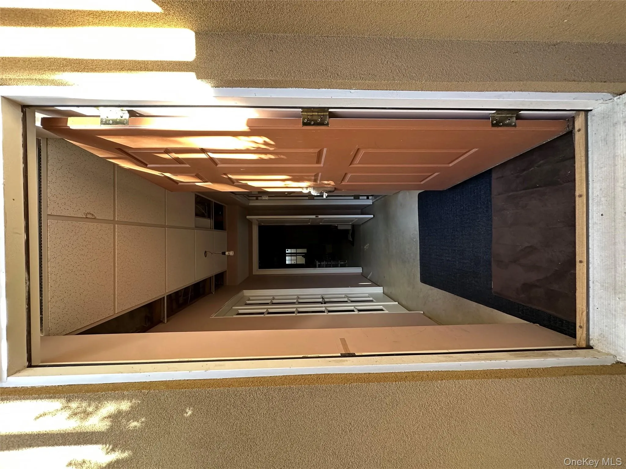 Corridor with a drop ceiling, concrete flooring, and french doors Corridor with a drop ceiling, concrete flooring, and french doors
