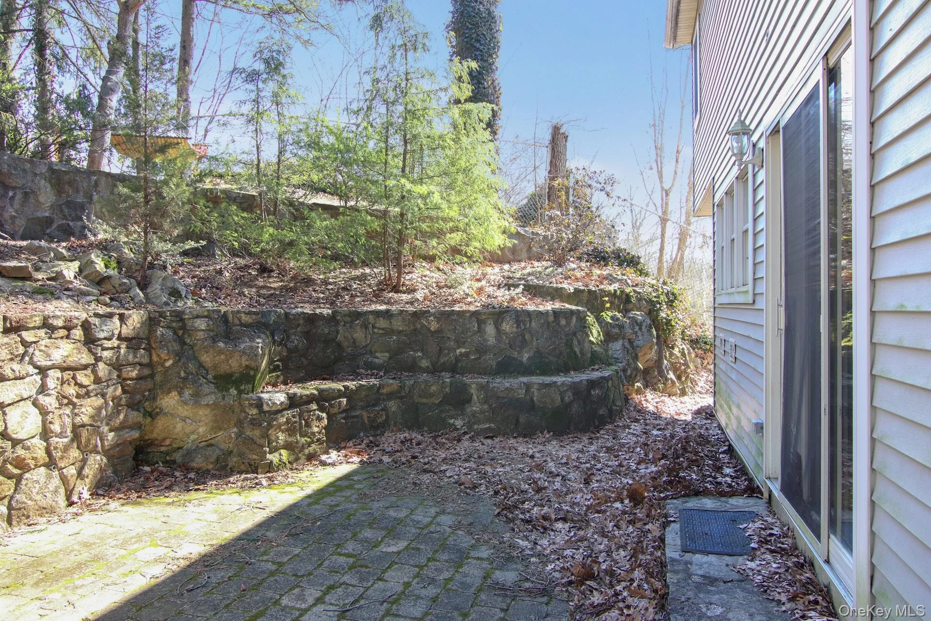 Stone Steps from the Patio lead to a flat yard above. Stone Steps from the Patio lead to a flat yard above.