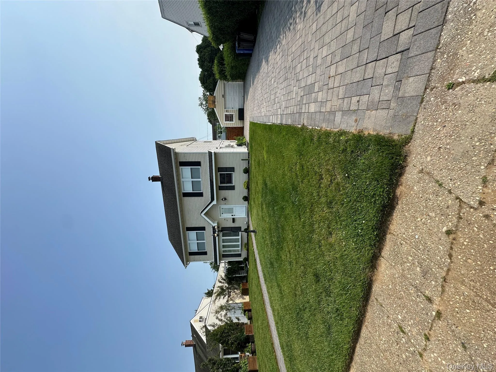 Traditional-style house featuring an outbuilding, a garage, a front lawn, and a chimney Traditional-style house featuring an outbuilding, a garage, a front lawn, and a chimney