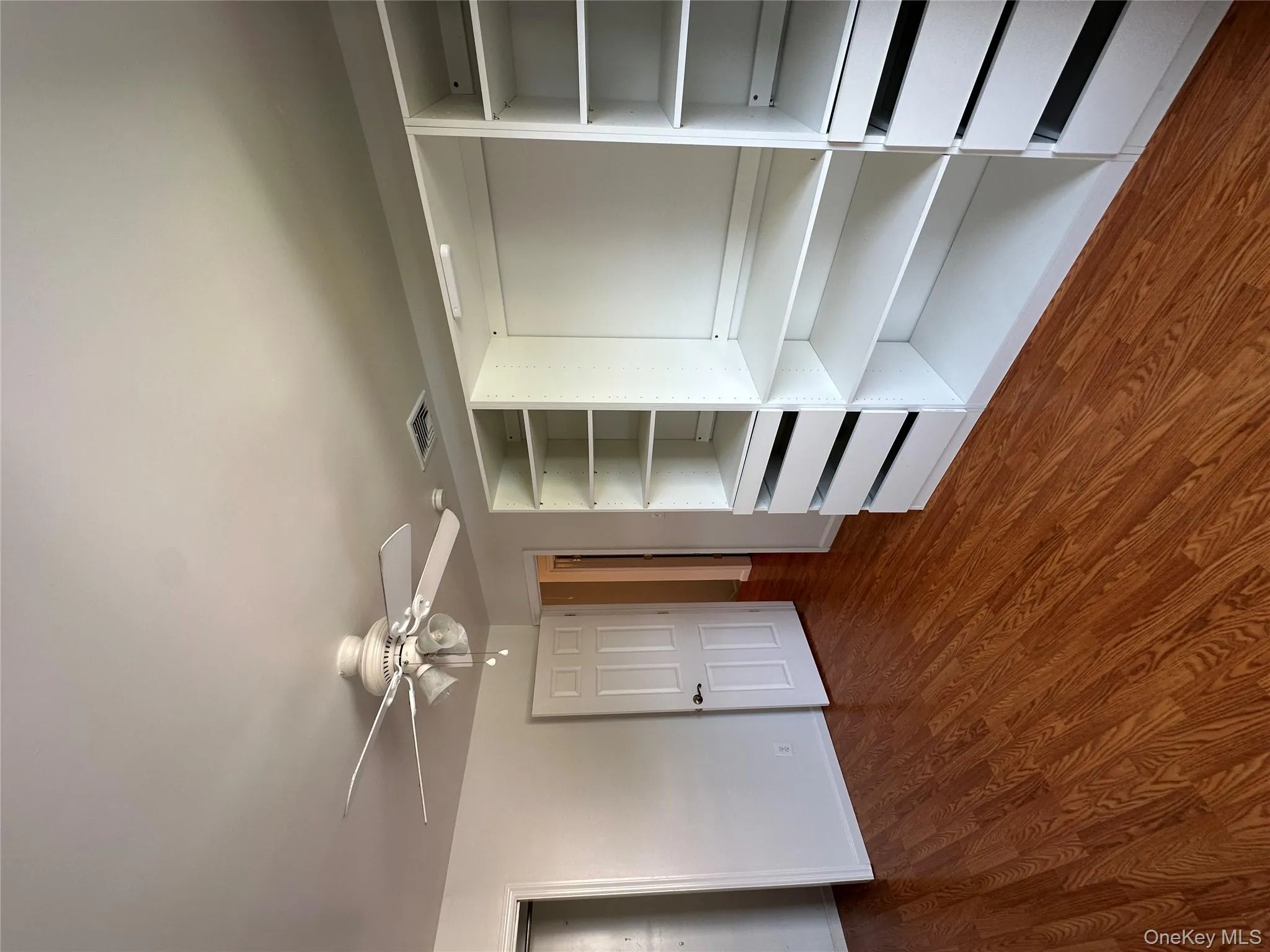 Unfurnished bedroom featuring dark wood-style floors and ceiling fan Unfurnished bedroom featuring dark wood-style floors and ceiling fan
