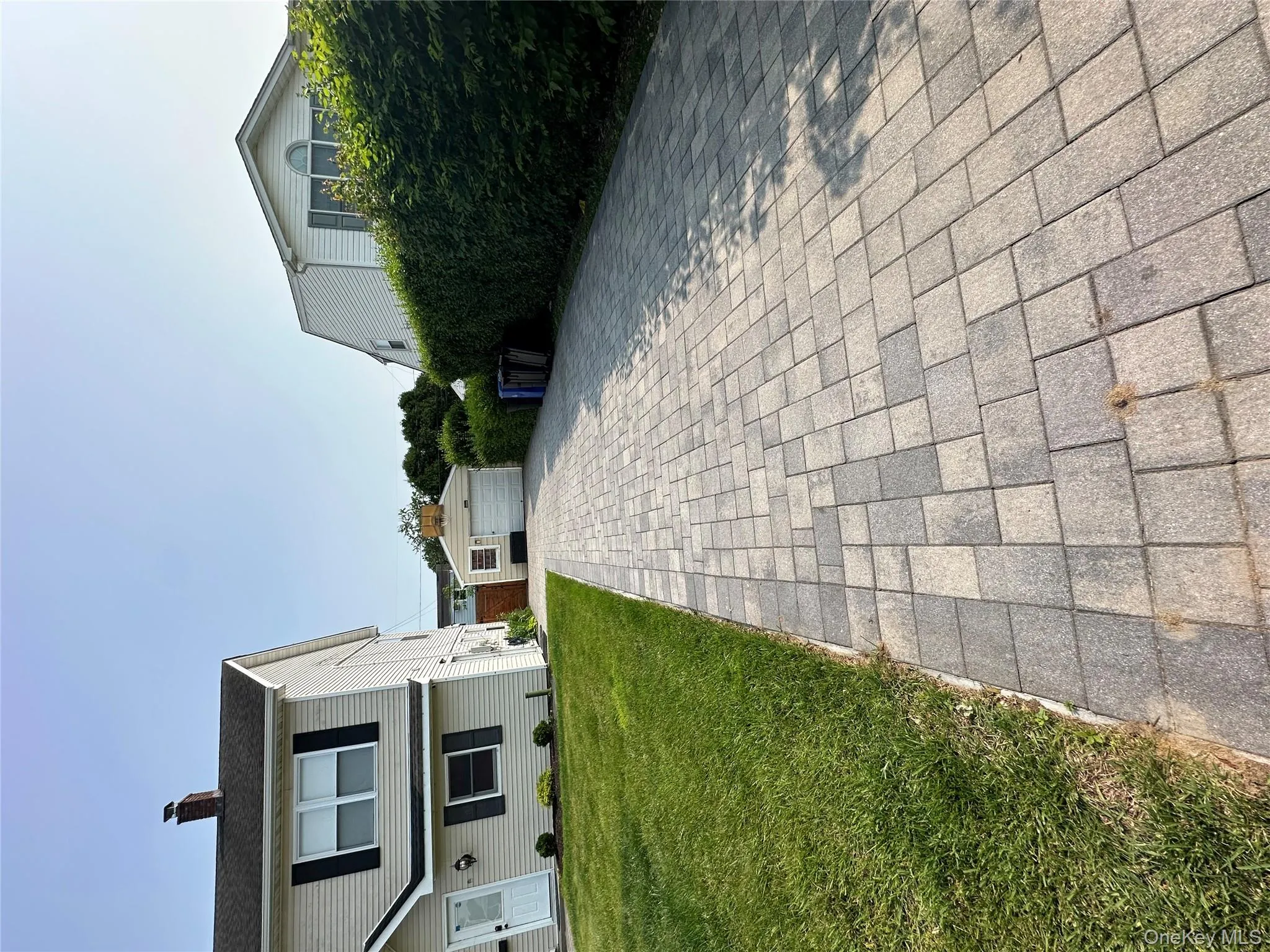 View of front of home with a detached garage, an outbuilding, a chimney, and a front lawn View of front of home with a detached garage, an outbuilding, a chimney, and a front lawn