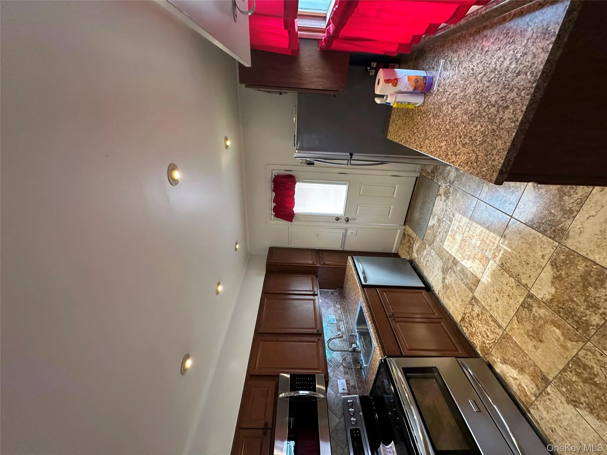 Kitchen featuring range, dishwasher, tasteful backsplash, recessed lighting, and fridge Kitchen featuring range, dishwasher, tasteful backsplash, recessed lighting, and fridge