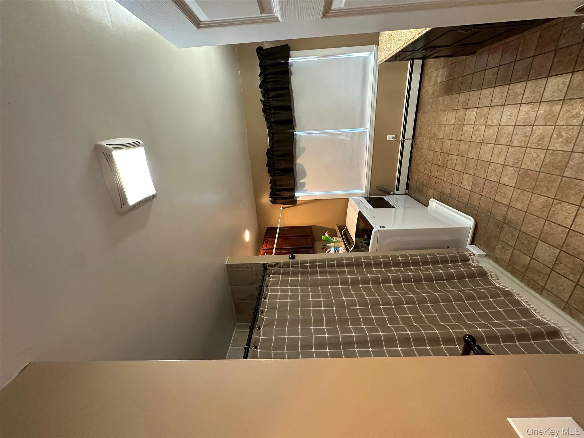 Full bath featuring a baseboard radiator, vanity, and a shower with shower curtain Full bath featuring a baseboard radiator, vanity, and a shower with shower curtain