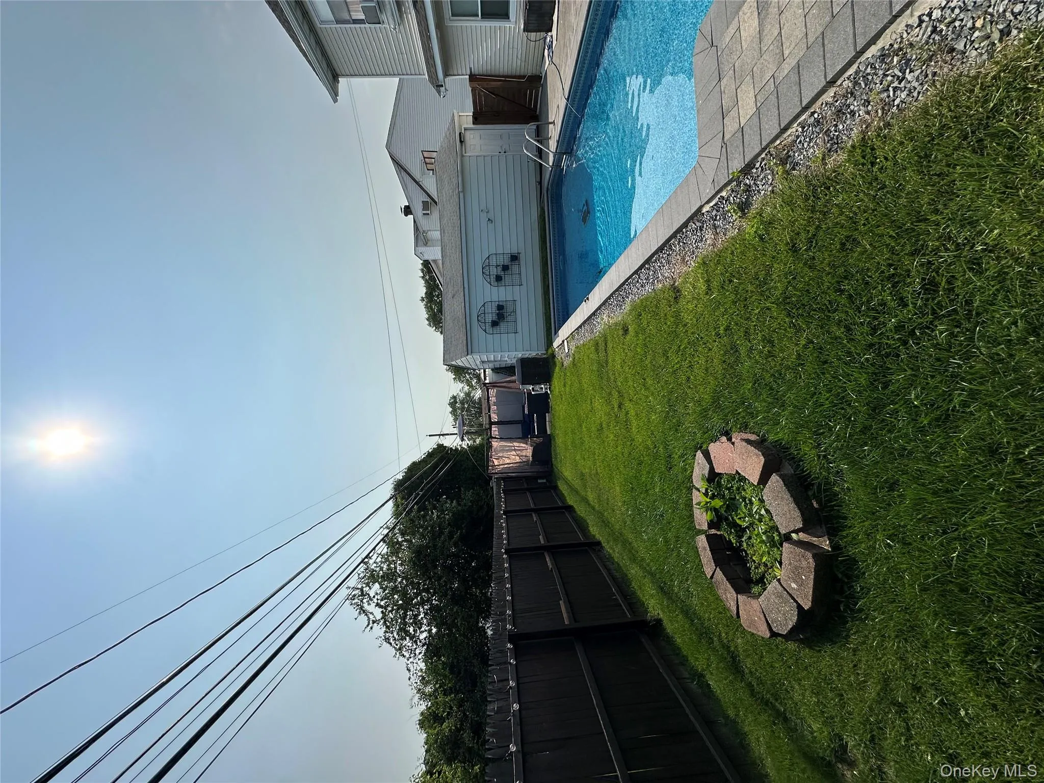 View of swimming pool with a fenced backyard and an outdoor structure View of swimming pool with a fenced backyard and an outdoor structure