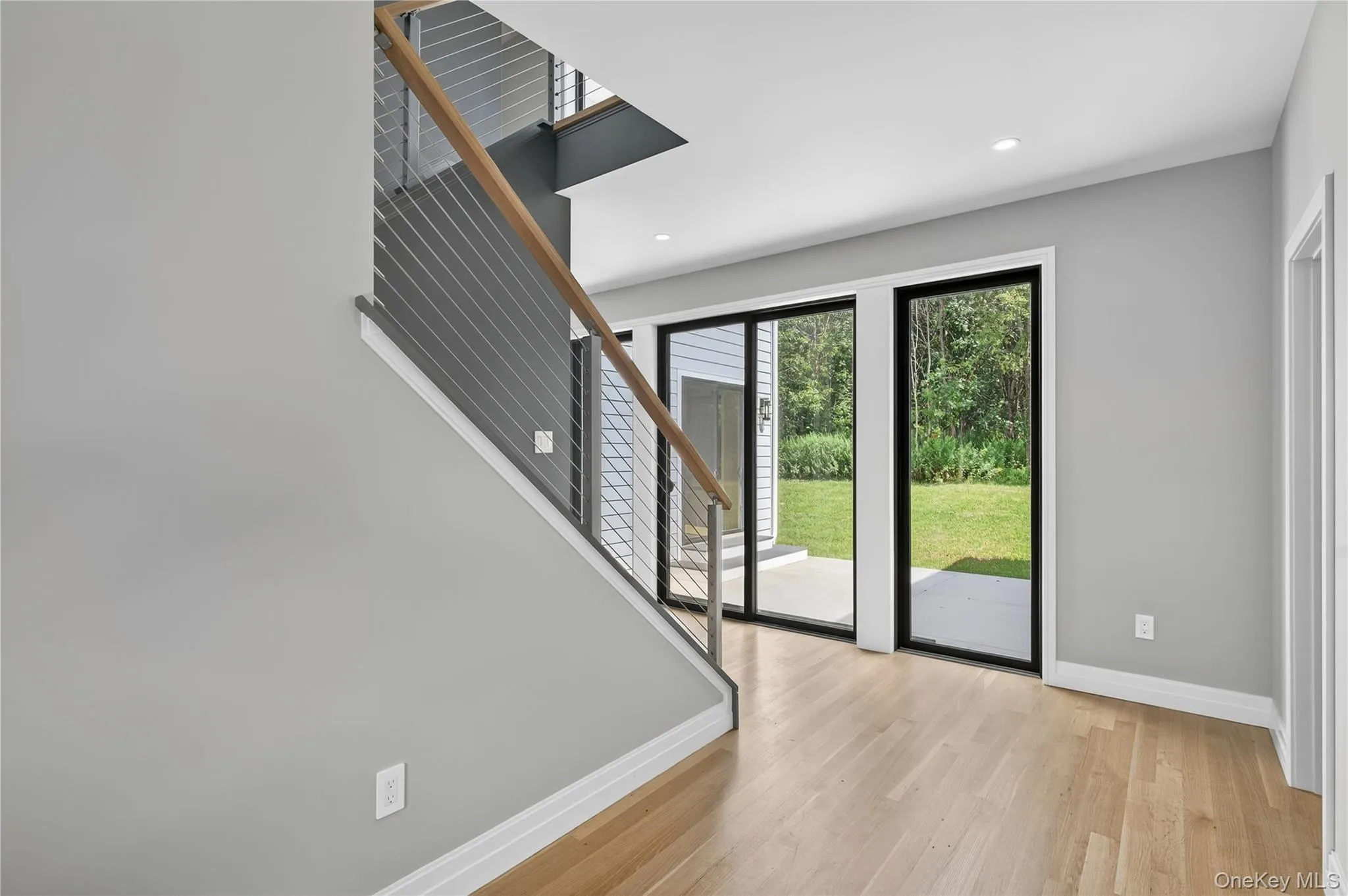 Foyer with light wood-style flooring, stairs, and recessed lighting Foyer with light wood-style flooring, stairs, and recessed lighting
