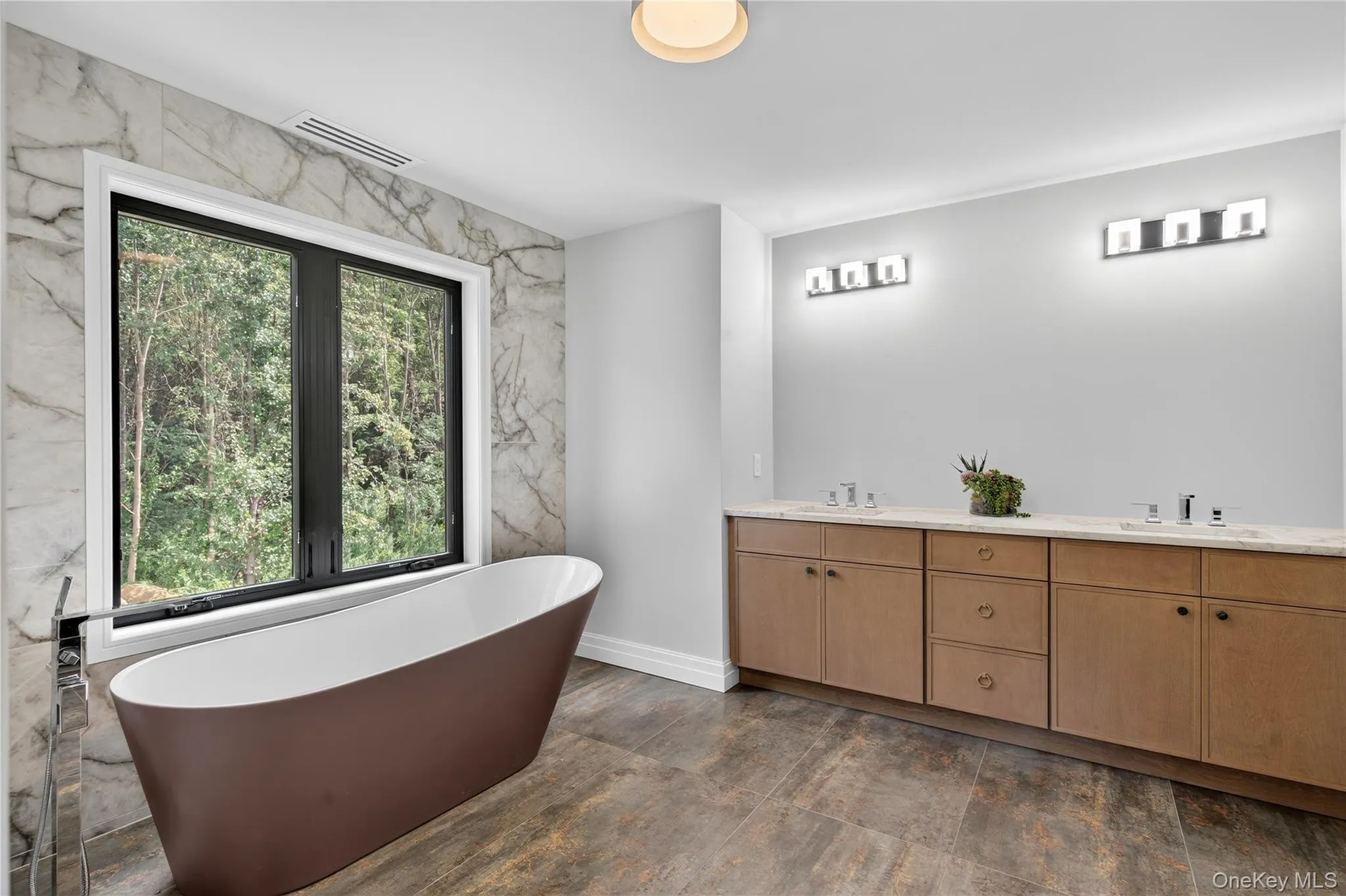 Bathroom featuring a soaking tub and double vanity Bathroom featuring a soaking tub and double vanity