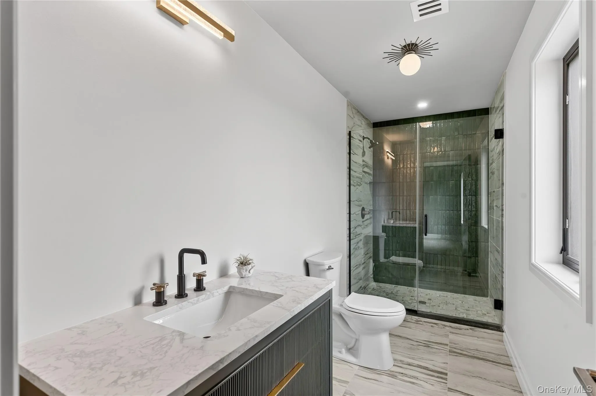 Bathroom featuring a shower stall, vanity, and recessed lighting Bathroom featuring a shower stall, vanity, and recessed lighting