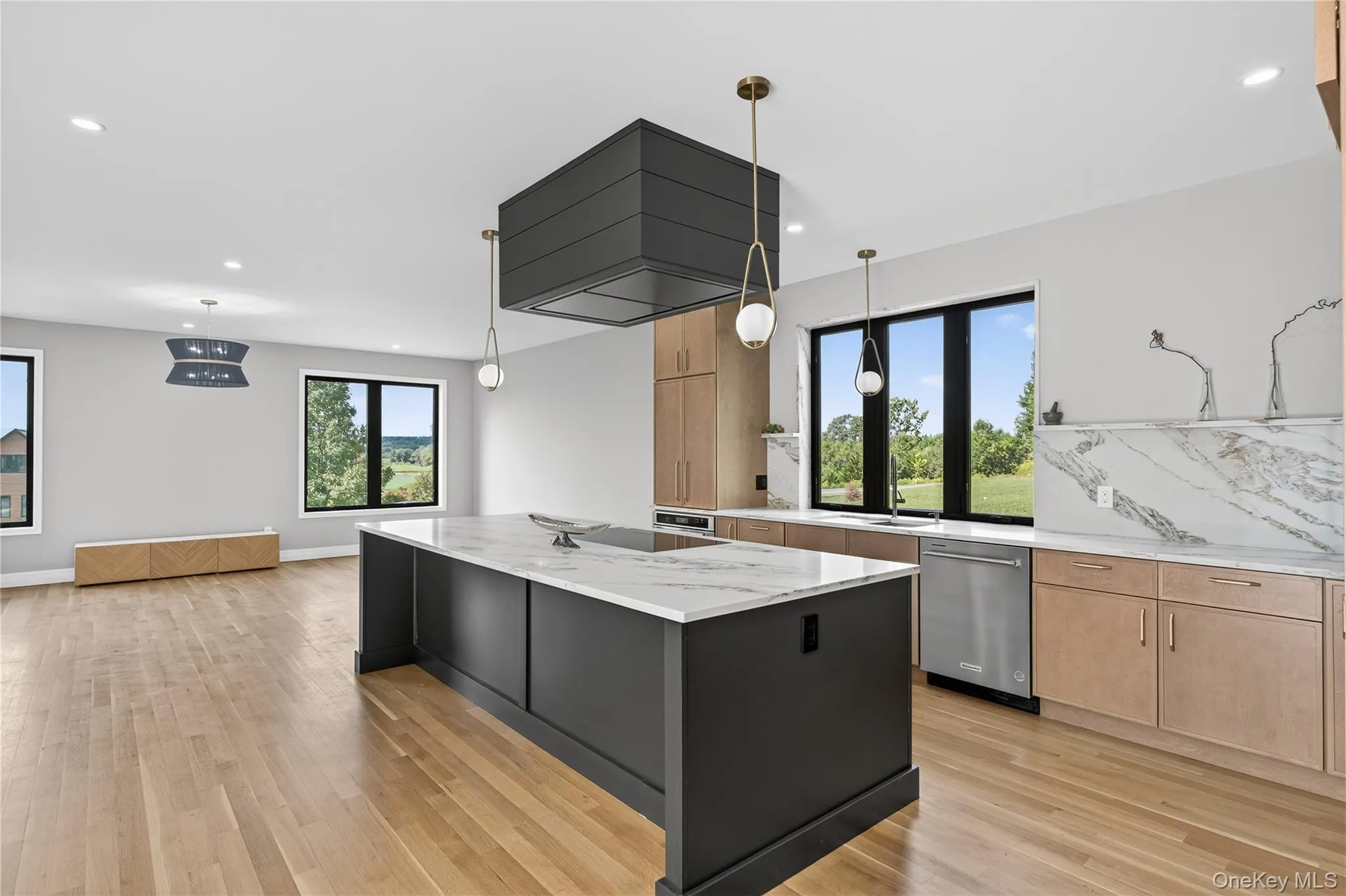 Kitchen featuring light brown cabinetry, stainless steel appliances, light stone counters, healthy amount of natural light, and recessed lighting Kitchen featuring light brown cabinetry, stainless steel appliances, light stone counters, healthy amount of natural light, and recessed lighting