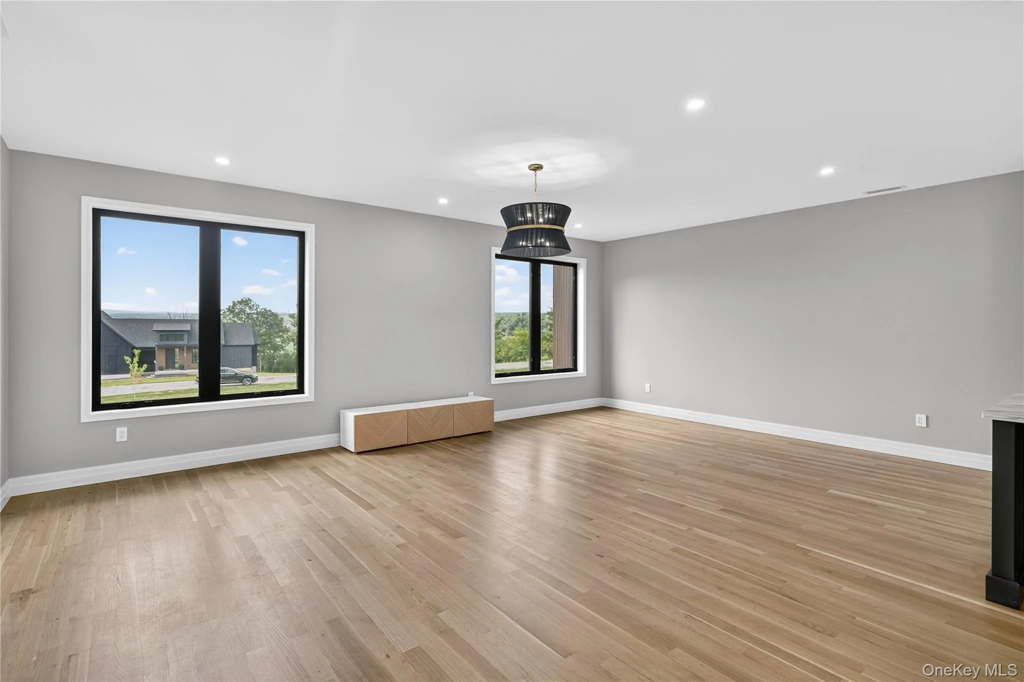 Unfurnished living room featuring light wood-type flooring and recessed lighting Unfurnished living room featuring light wood-type flooring and recessed lighting