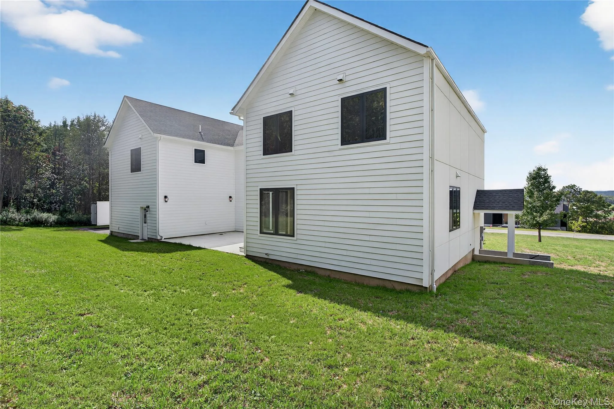 Rear view of house featuring a lawn and a patio Rear view of house featuring a lawn and a patio