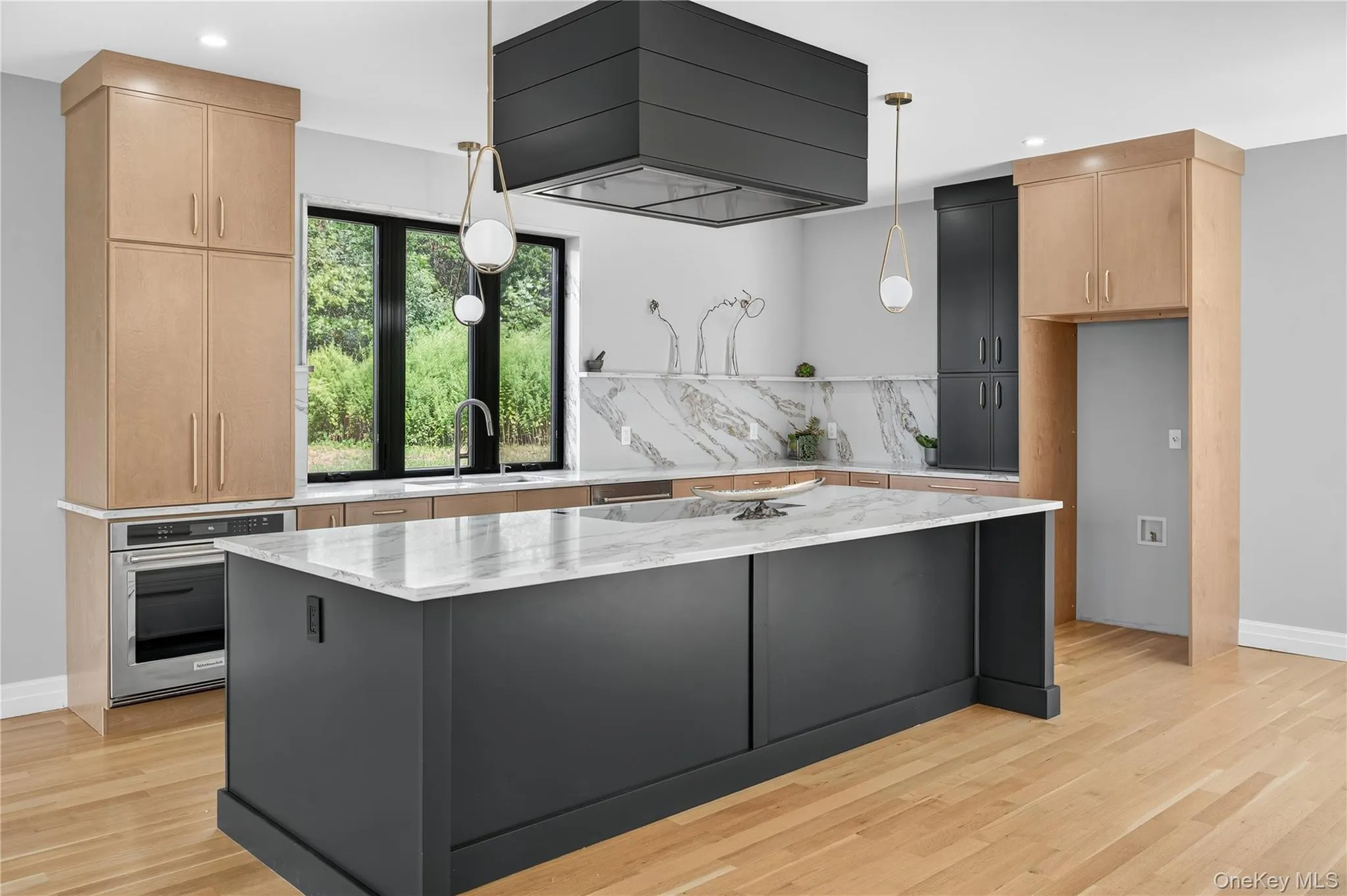 Kitchen featuring light stone countertops, stainless steel oven, decorative light fixtures, wall chimney exhaust hood, and recessed lighting Kitchen featuring light stone countertops, stainless steel oven, decorative light fixtures, wall chimney exhaust hood, and recessed lighting