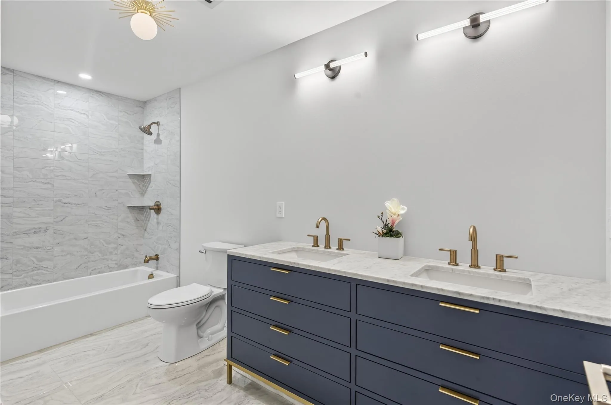 Bathroom with shower / washtub combination, double vanity, and recessed lighting Bathroom with shower / washtub combination, double vanity, and recessed lighting
