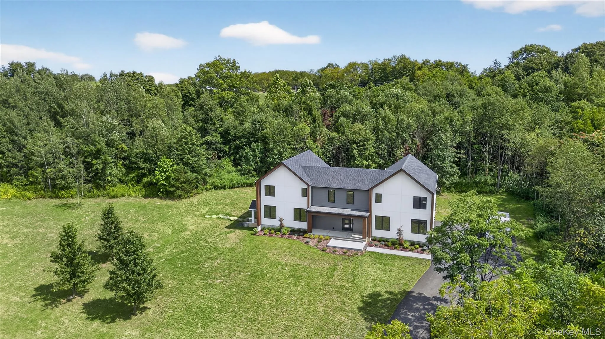 View from above of property with a heavily wooded area View from above of property with a heavily wooded area